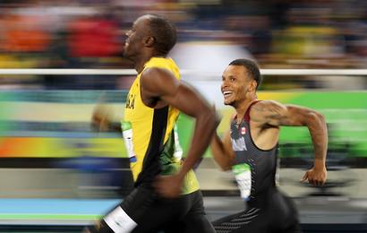 Usain Bolt of Jamaica and Andre De Grasse of Canada smile as they compete in the semi-final of the men's 200m - Olympic Stadium - Rio de Janeiro