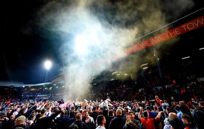 Luton fans celebrate on the pitch after victory over Sunderland